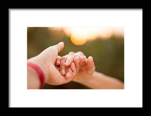 People Framed Print featuring the photograph Holding hands during sunset by Anshu