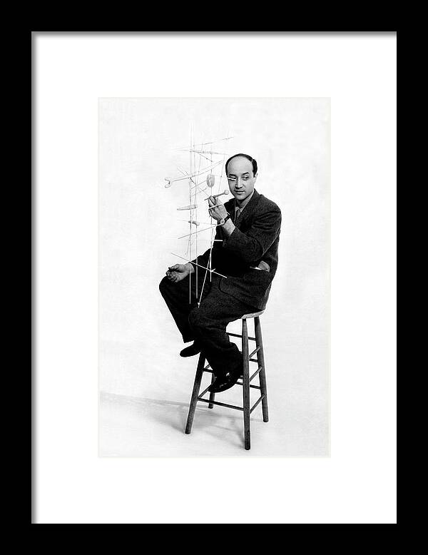 Designer Framed Print featuring the photograph Isamu Noguchi Holding One Of His Structures by Herbert Matter