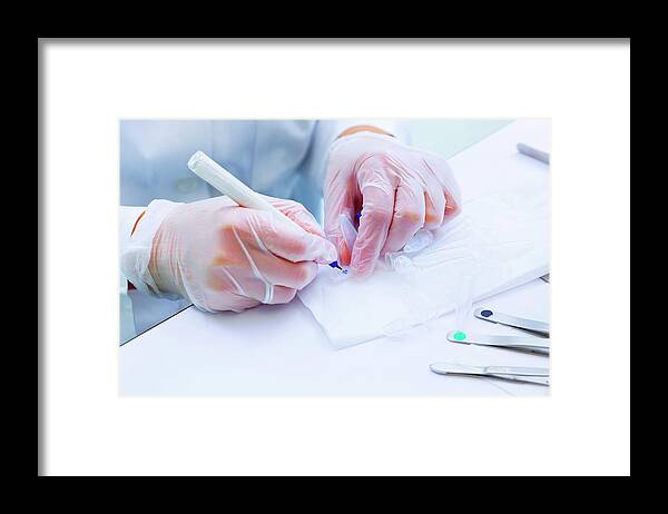 One Person Framed Print featuring the photograph Lab Technician Writing On Test Tube by Wladimir Bulgar