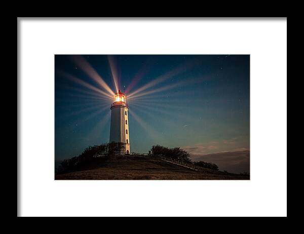 Vacations Framed Print featuring the photograph Lighthouse on a hill shining at night by Daniela Garling