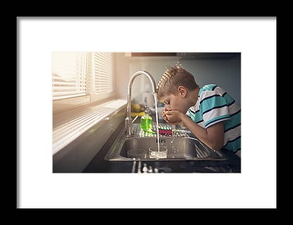 Child Framed Print featuring the photograph Little boy drinking tap water by Imgorthand