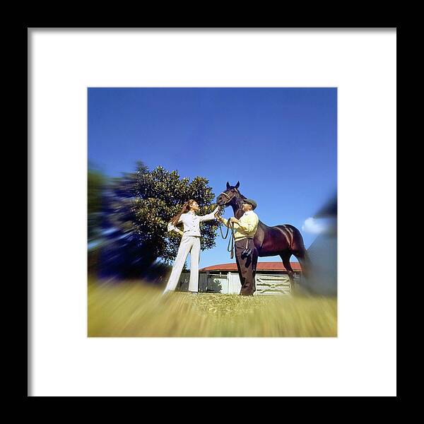 Fashion Framed Print featuring the photograph Marisa Berenson Standing By A Horse by Arnaud de Rosnay
