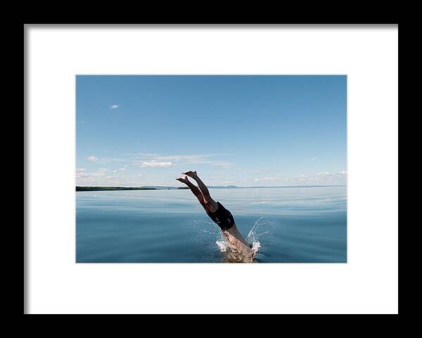 Scenics Framed Print featuring the photograph Mature Man Jumping In Sea by Johner Images