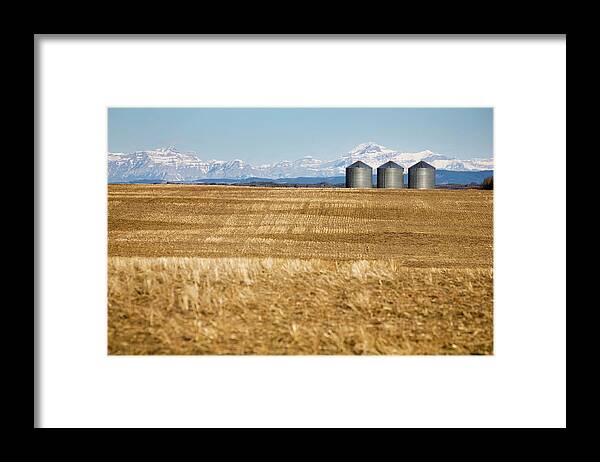 Storage Compartment Framed Print featuring the photograph Metal Grain Bins In Stubble Field With by Michael Interisano / Design Pics