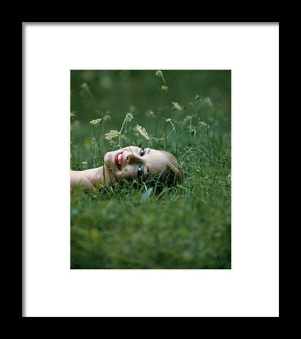 One Person Framed Print featuring the photograph Model Gretchen Harris Lying In A Field by Karen Radkai