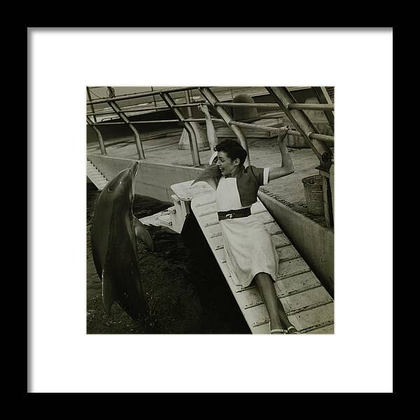 Accessories Framed Print featuring the photograph Model Wearing A Cannon Outfit By A Dolphin by Toni Frissell Accessories Framed Print featuring the photograph Model Wearing A Cannon Outfit By A Dolphin by Toni Frissell