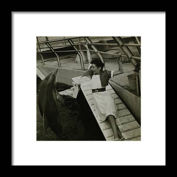 Accessories Framed Print featuring the photograph Model Wearing A Cannon Outfit By A Dolphin by Toni Frissell