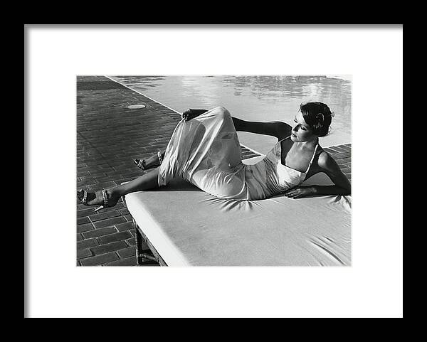 Exterior Framed Print featuring the photograph Model Wearing A Leonard Dress Poolside by Kourken Pakchanian