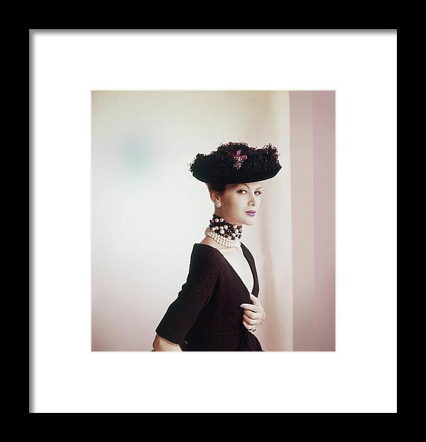 Studio Shot Framed Print featuring the photograph Model Wearing Black Hat With Feathers by Horst P. Horst