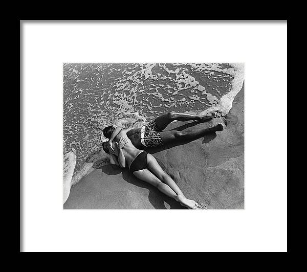 Model Framed Print featuring the photograph Models Embracing On A Beach by Mark Patiky