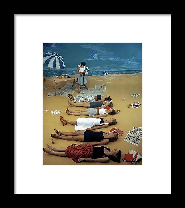 Fashion Framed Print featuring the photograph Models Lying On A Fake Beach Set At A Studio by Serge Balkin