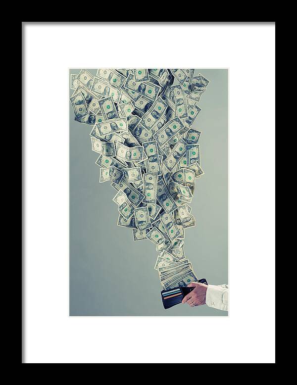 Debt Framed Print featuring the photograph Money flying out of man's wallet by PM Images