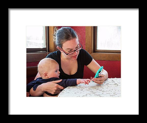 Human Framed Print featuring the photograph Mother And Baby Using A Mobile Device by Jim West