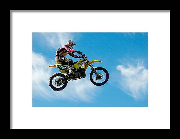 Motocross Framed Print featuring the photograph Motocross rider jumping high - blue sky by Matthias Hauser