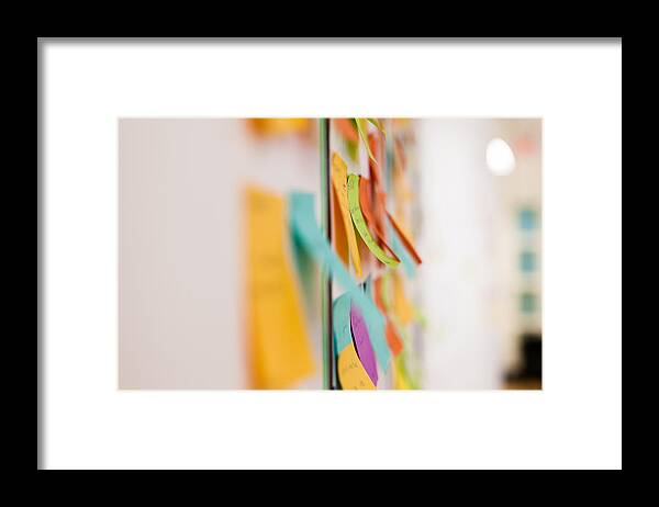 Whiteboard Framed Print featuring the photograph Multicolored sticky notes on whiteboard by Evgeny Tchebotarev