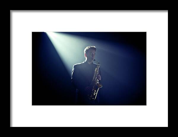 People Framed Print featuring the photograph Musician Playing Saxophone On Stage by Tooga