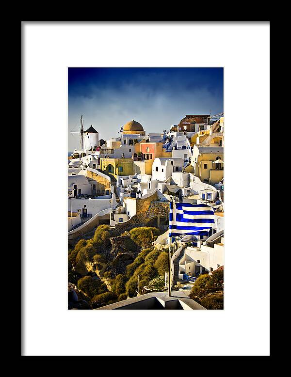 Santorini Framed Print featuring the photograph Oia and a greek flag by Meirion Matthias