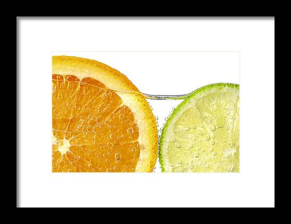 Orange Framed Print featuring the photograph Orange and lime slices in water by Elena Elisseeva