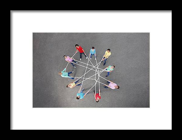 Young Men Framed Print featuring the photograph People playing with tangled string by Photo_Concepts