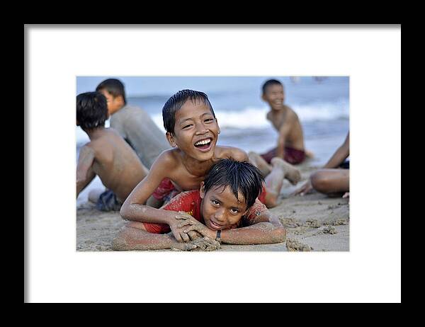 Children Framed Print featuring the photograph Playing on the beach by Achmad Bachtiar