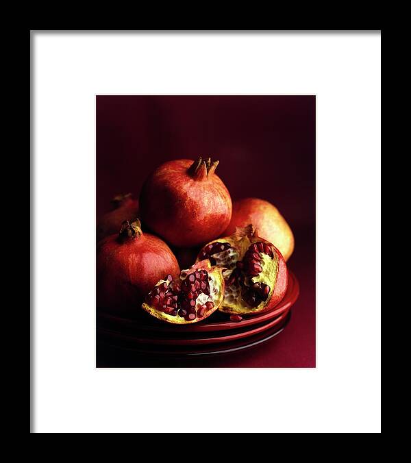 Fruitsvegetablespomegranatestudio Shotnobodystill Lifeplatetablewarefruitfoodhealthy Eatingopenredshadow #condenastgourmetphotograph January 1st 2000 Framed Print featuring the photograph Pomegranates by Romulo Yanes