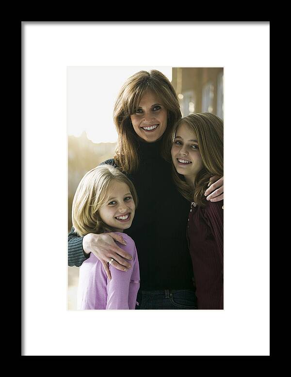 Mid Adult Women Framed Print featuring the photograph Portrait of a mid adult woman with her daughters by Photodisc