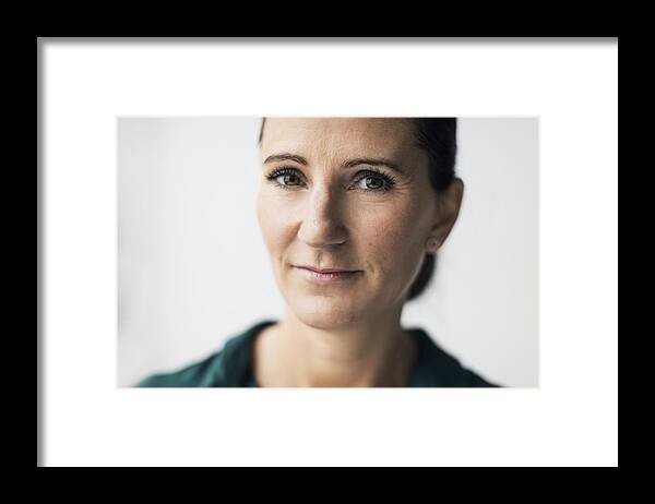 Mature Adult Framed Print featuring the photograph Portrait of confident mature woman over white background by Maskot