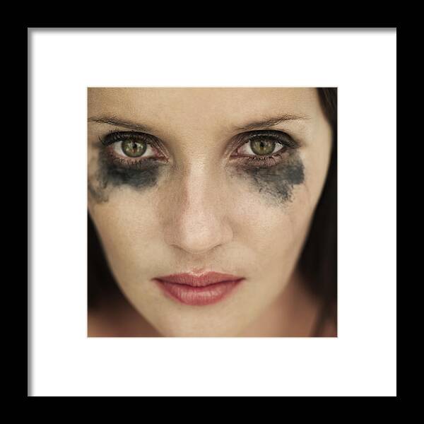 Caucasian Ethnicity Framed Print featuring the photograph Portrait of woman with running eye mascara by Stockbyte