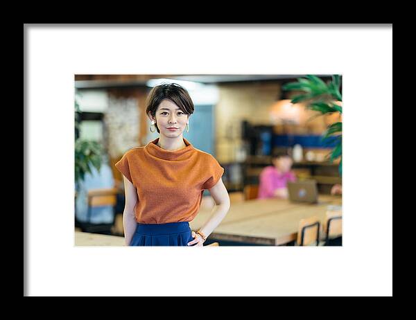 Asian And Indian Ethnicities Framed Print featuring the photograph Portrait of young business woman in modenr co-working space by Recep-bg