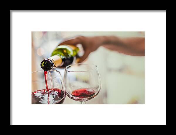 Material Framed Print featuring the photograph Pouring red wine in glasses by Instants