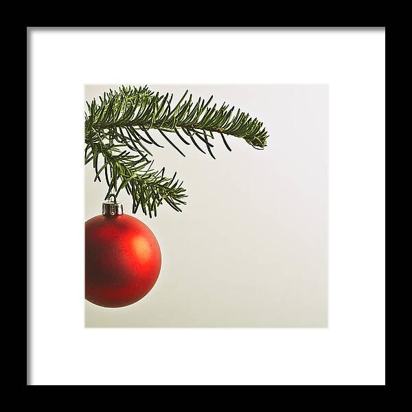 Hanging Framed Print featuring the photograph Red Christmas bauble hanging from Christmas tree by PhotoAlto/Michele Constantini