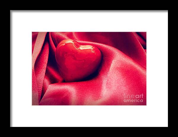 Heart Framed Print featuring the photograph Red heart in satin cloth by Michal Bednarek
