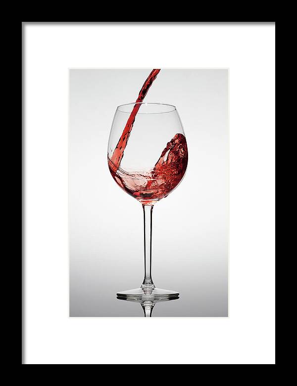 Alcohol Framed Print featuring the photograph Red Wine Being Poured Into A Glass by Dual Dual