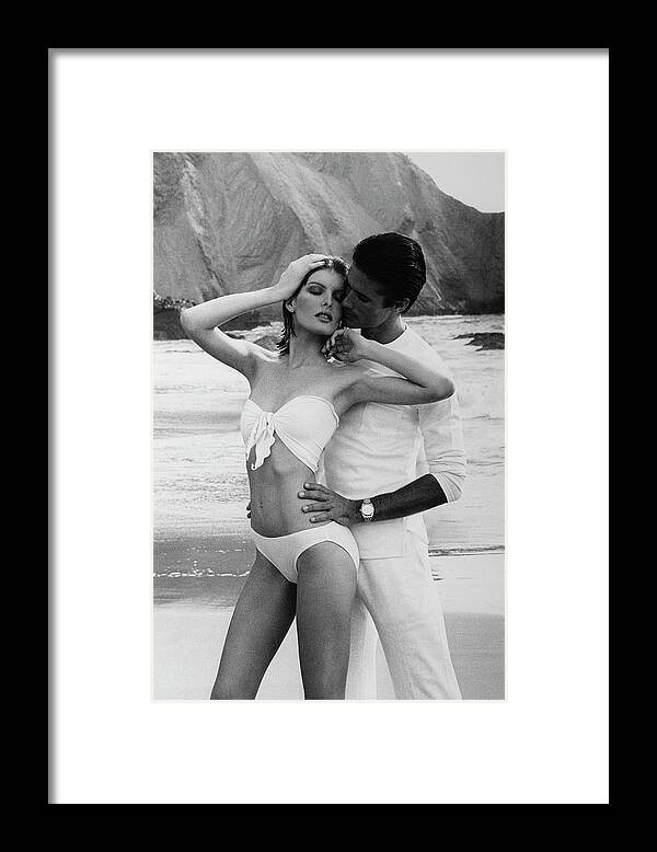 Beauty Framed Print featuring the photograph Rene Russo Posing With A Male Model On A Beach by Francesco Scavullo