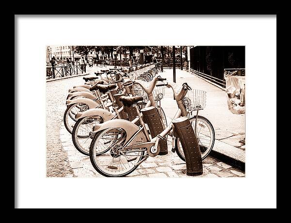 Paris Bikes Framed Print featuring the photograph Rent A Bike in Paris Toned by Georgia Clare