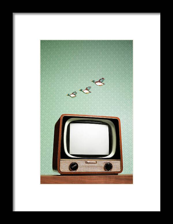 Humor Framed Print featuring the photograph Retro Tv With Flying Ducks On The Wall by Peter Dazeley