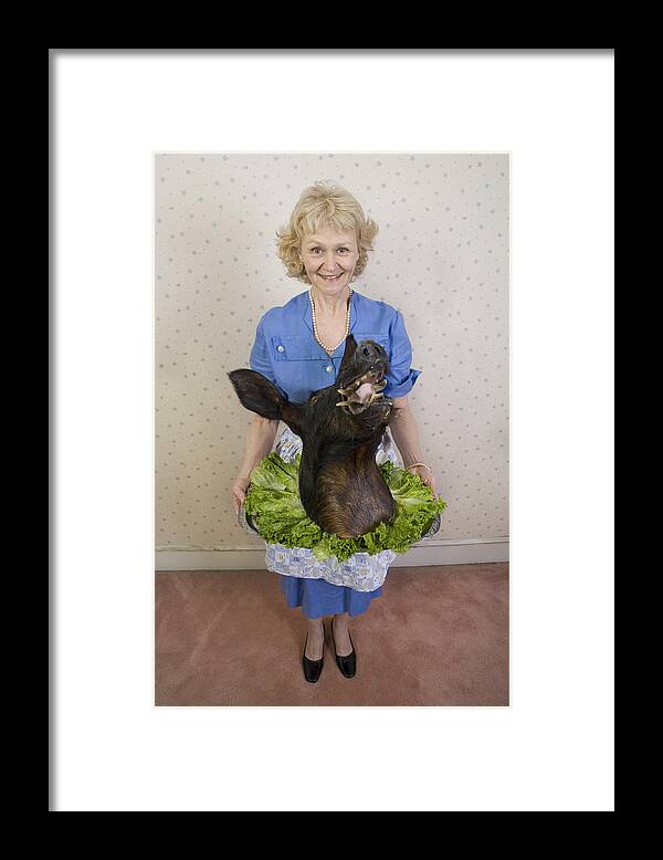 Pig Framed Print featuring the photograph Senior woman holding wild boars head, portrait, high angle view by Sheer Photo, Inc