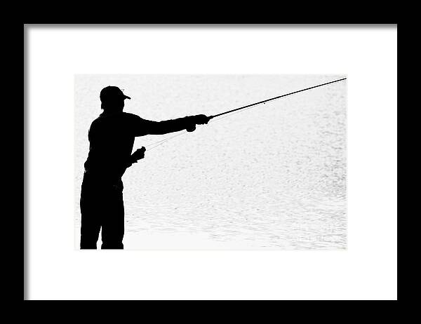Silhouette of a Fisherman Holding a Fishing Pole BW Framed Print
