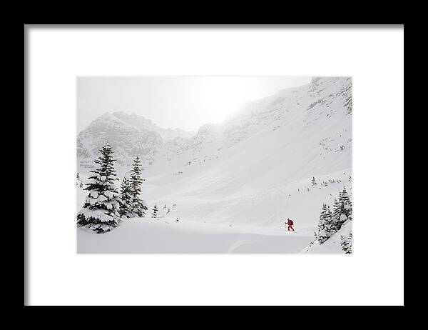 Skiing Framed Print featuring the photograph Skier Climbs Snowy Ridge Below Misty by Ascent Xmedia