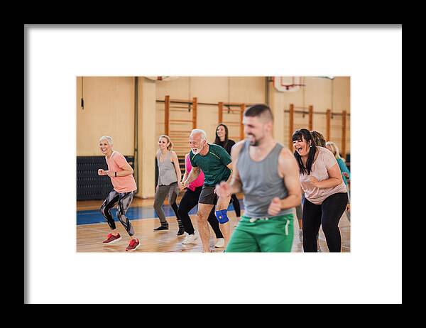 Diversity Framed Print featuring the photograph Smiling and happy group of people dancing at gym by Anchiy