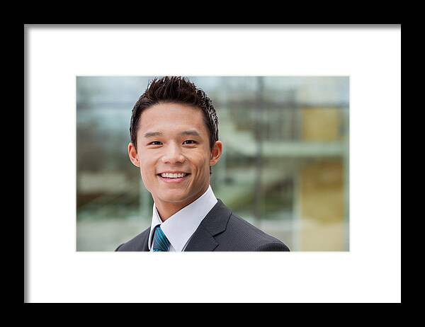 Working Framed Print featuring the photograph Smiling businessman by FangXiaNuo