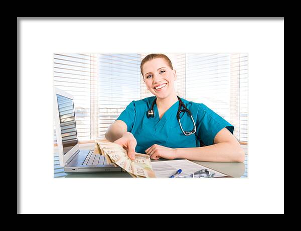Expertise Framed Print featuring the photograph Smiling nurse holding canadian money by ChristopherBernard