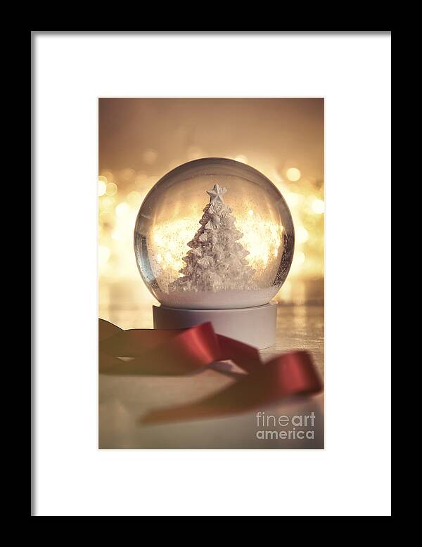 Background Framed Print featuring the photograph Snow globe against a warm holiday background by Sandra Cunningham