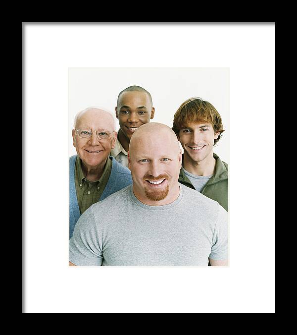 Young Men Framed Print featuring the photograph Studio Portrait of Four Smiling Men of Mixed Ages by Digital Vision.