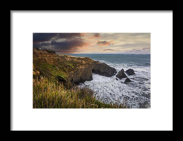 Clouds Framed Print featuring the photograph Sunset over the Oregon Coast by Debra and Dave Vanderlaan