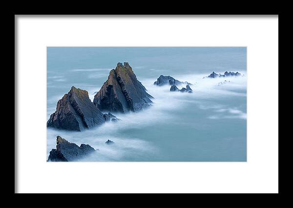 Scenics Framed Print featuring the photograph Swirling Tide Around Jagged Rocks by Sebastian Wasek