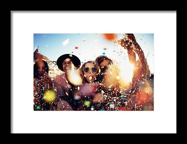 Hipster Framed Print featuring the photograph Teenager hipster friends partying by blowing colorful confetti from hands by Wundervisuals