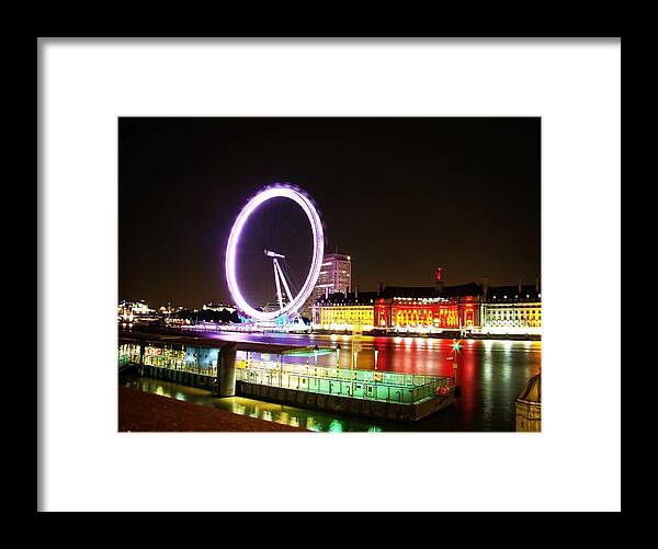 The London Eye Framed Print featuring the photograph The Eye in Colors by Zinvolle Art