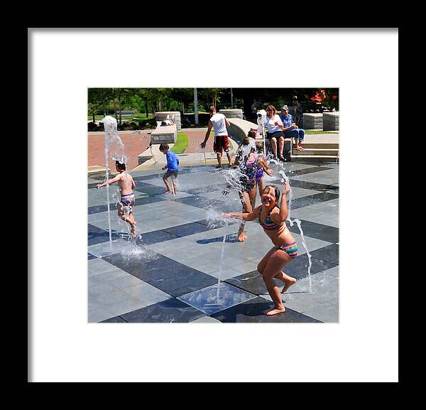 Child Playing In Water Fountain Framed Print featuring the photograph Joyful Young Girl Playing in Fountain by Ginger Wakem