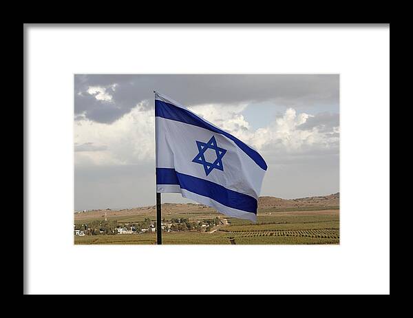 Golan Heights Golan Heights Golan Framed Print featuring the photograph The flag of Israel waving in the Golan Heights israel by Ronald Jansen